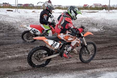 Motocross rider two accelerated away from the turningの写真素材
