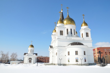 White church with golden domes and bell tower in the winter sunny dayの写真素材