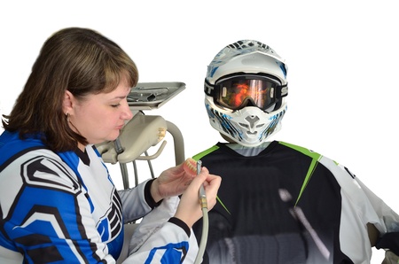 Woman dentist in the hands of dental prostheses in the form at the dental chair is casual shirt and a motorcycle helmet on a clean backgroundの写真素材