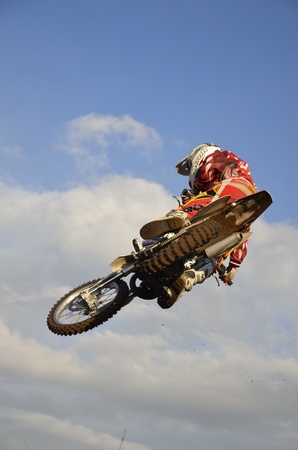 RUSSIA, SAMARA, CHAPAYEVSK - OCTOBER 17: Motocross racer I. Baranov in-flight with large horizontal tilt the Open Cup "Volga" motocross on October 17, 2011 in Chapayevsk, Samara, Russiaのeditorial素材