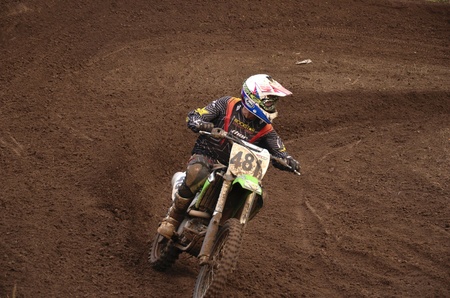 RUSSIA, SAMARA, CHAPAYEVSK - OCTOBER 17: Motorcycle racer S. Astaikin turns with proslipping the Open Cup "Volga" motocross on October 17, 2011 in Chapayevsk, Samara, Russiaのeditorial素材