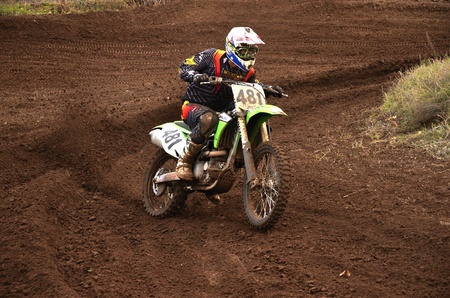 RUSSIA, SAMARA, CHAPAYEVSK - OCTOBER 17: Motorcycle racer S. Astaikin turns with proslipping the Open Cup "Volga" motocross on October 17, 2011 in Chapayevsk, Samara, Russiaのeditorial素材
