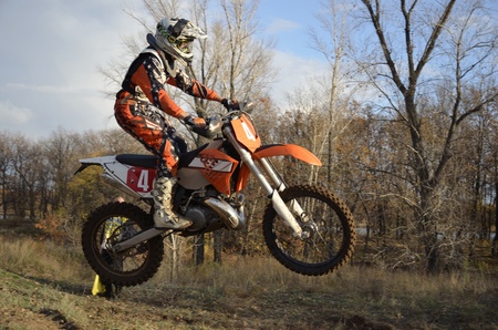 A jump rider on a motorcycle on the background an autumn forestのeditorial素材