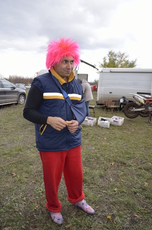 A man in a funny pink hat and a bandaged hand, smilingの写真素材