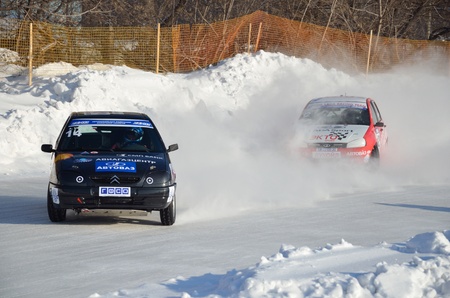 RUSSIA SAMARA - FEBRUARY 12: Two cars compete at the turning the track, Cup of Russia in Speedway car on ice February 12, 2012 in Samara, Russiaのeditorial素材