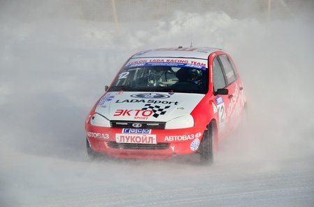 RUSSIA SAMARA - FEBRUARY 12: Sports car by turning the glides on the track in the thick dust of snow, Cup of Russia in winter track motor racing February 12, 2012 in Samara, Russiaのeditorial素材