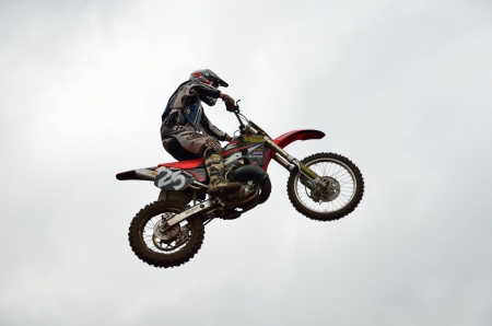 RUSSIA, SAMARA - JUNE 11: High flight of motorcycle racer A. Stepanov  on the background of clouds the Open class the Regional Motocross Championship on June 11, 2012 in Samara, Russiaのeditorial素材