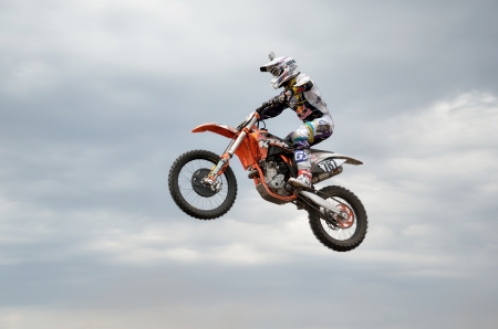 RUSSIA, SAMARA - MAY 6: MX racer D. Vintaev performs a jump in background of clouds, the Open class the Regional Motocross Championship on Mau 6, 2012 in Samara, Russiaのeditorial素材