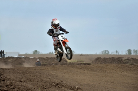 RUSSIA, SAMARA  MAY 6: The boy I. Gavrilov on the bike jumps from the edge of the hill track MX, the 50 sm3 class the Regional Motocross Championship on May 6, 2012 in Samara, Russiaのeditorial素材