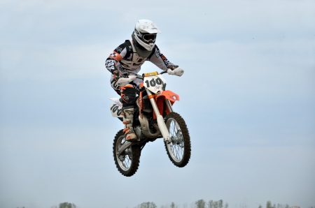 RUSSIA, SAMARA  MAY 6: MX  young participant E. Pershin on a motorcycle in the air, on the background of the cloudy sky  the 85 sm3 class the Regional Motocross Championship on May 6, 2012 in Samara, Russiaのeditorial素材