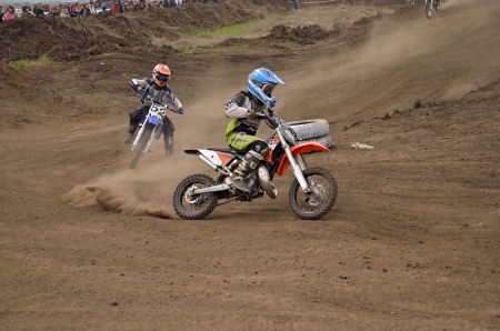 RUSSIA, SAMARA  MAY 6: Youngest participant the MX 104 N. Kornev, 52 B. Forvazov on departure from the turning, the 65 sm3 class the Regional Motocross Championship on May 6, 2012 in Samara, Russiaのeditorial素材