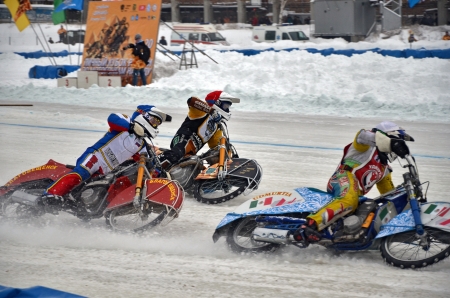 SAMARA, RUSSIA - JANUARY 19: Three riders white Sergei Boldachev, blue Daniel Golosheykin, red Vasily Kosov compete on corner entry on the ice speedway Cup of Russia January 19, 2013 in Samara, Russiaのeditorial素材