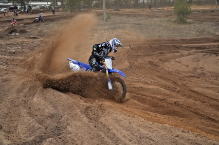 RUSSIA, SAMARA - APRIL 6: Motocross racer Yu Panfilov leaves the deep sandy ruts, motocross workout April 6, 2013 in Samara, Russiaのeditorial素材