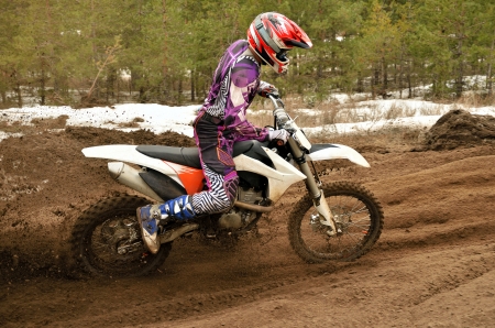 racer off the corner on the sandy motocross trackの写真素材