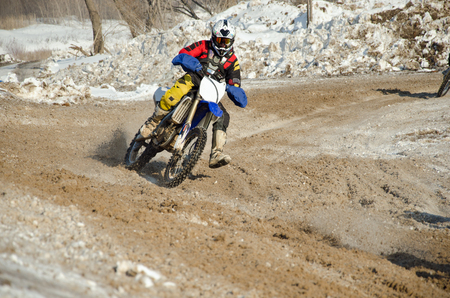 Motocross rider on the motorcycle accelerates from turningの写真素材
