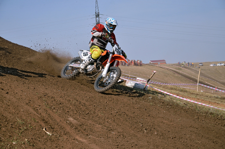 RUSSIA, SAMARA - SEPTEMBER 26: Racer V. Subbotin on a motorcycle turns on a mountain slope with slip, Regional Motocross Championship on September 26, 2015 in Samara, Russiaのeditorial素材