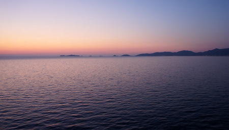 In crimson tones, or arriving at the island of Corsica late spring evening.の写真素材