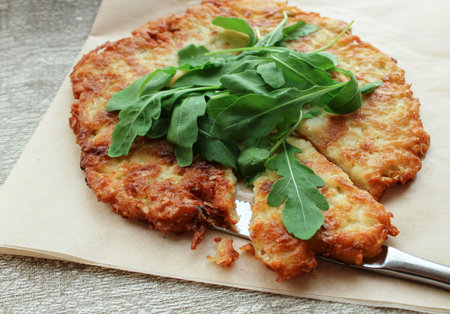 fried potato cakes with arugula