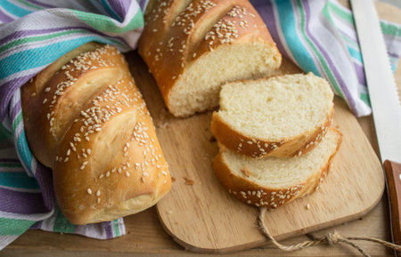 French baguette on a wooden board covered with a towel