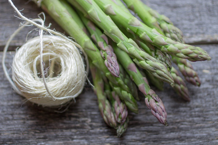 ripe green asparagus on a wooden backgroundの写真素材