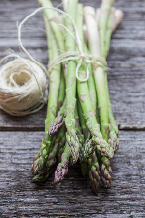 ripe green asparagus on a wooden backgroundの写真素材