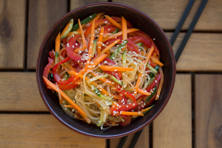 glass noodles with carrot, bell pepper, carrots and sesame seedsの写真素材