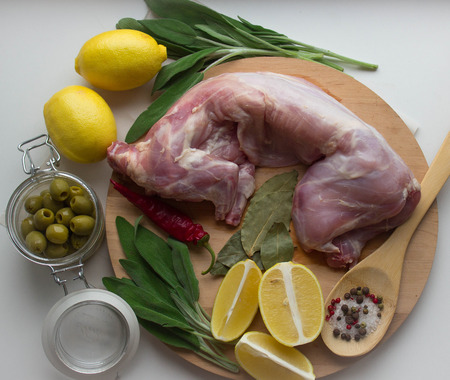 raw rabbit and spices - lemon, sage, pepper, Bay leaf, olivesの写真素材