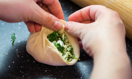 Cooking pies with cheese and herbsの写真素材