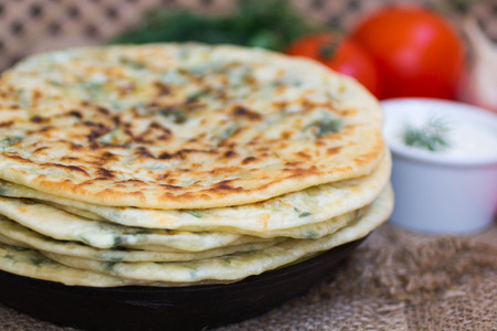 Thin pie with herbs and cheese. selective focusの写真素材