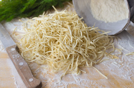 Fresh homemade noodles with dill on the table