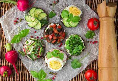 Sandwiches for the picnic of dark bread, cream cheese, herbs and fresh vegetables