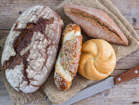A loaf of dark bread and a small bread on the table