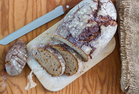 Freshly baked bread from rye flour on wooden table