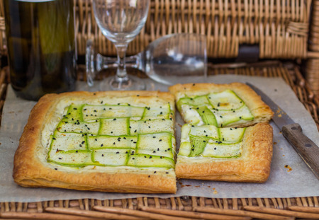 Homemade tart  of puff pastry with strips of fresh zucchini and goat cheese. Selective Focusの写真素材