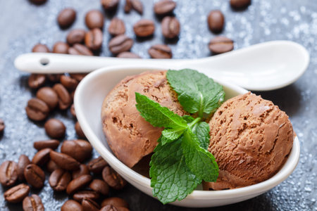 Coffee ice cream with mint leaves in a white Cup