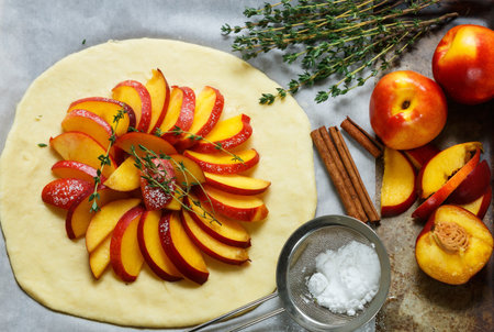 Baking a fruit pie with peaches, nectarines. The ingredients on the table - dough, peaches,...