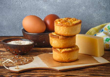 Mini pies with cheese, onion and egg. Tartlets. Delicious snack for gourmands. Selective focus