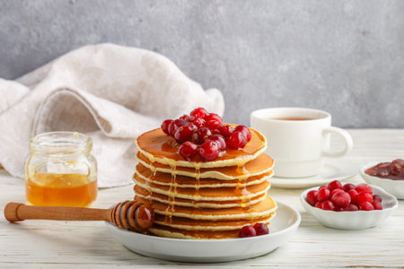 Pancake with honey and fresh berries. Cranberry, cowberry. Gourmet Breakfast. Selective focus