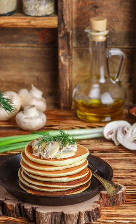 Pancake (potatoes , cheese) with mushrooms and cream sauce. Breakfast. Dinner.  rustic style. Selective focusの写真素材