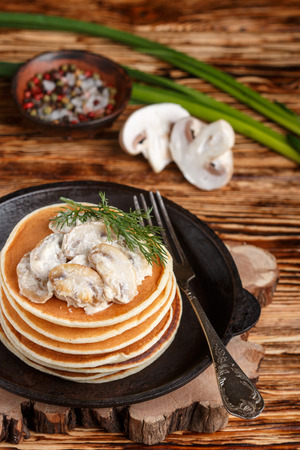 Pancake (potatoes , cheese) with mushrooms and cream sauce. Breakfast. Dinner.  rustic style. Selective focusの写真素材