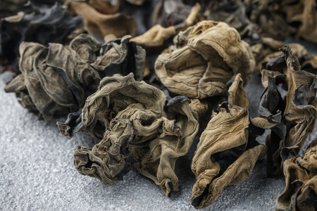 Dry black Chinese mushrooms. Ears. Traditional a popular ingredient for cooking Oriental and Asian cuisine. Selective focusの写真素材