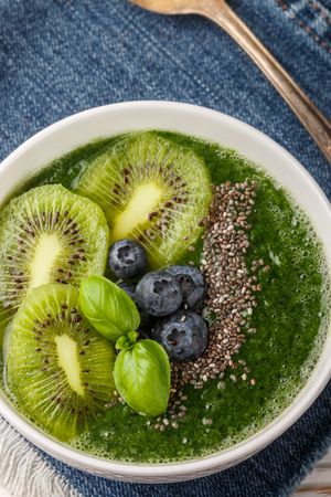 Healthy green smoothie spinach, banana,   avocado, kiwi with Chia seeds and blueberries. Detox. Healthy Breakfast. Selective focusの写真素材