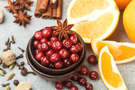 Ingredients for cooking traditional spicy winter drinks - cranberry, citrus, cinnamon, cardamom, star anise, cloves, pepper. Non-alcoholic mulled wine. Punch. The compote. Morseの写真素材