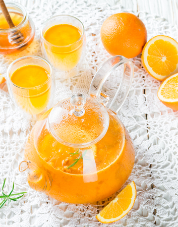 Tea made from sea buckthorn or cloudberries with orange and rosemary. Hot vitamin drink. Selective focusの写真素材