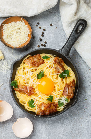 Traditional pasta - spaghetti Carbonara with cheese, bacon, parsley and egg yolk. The gourmet dinner. Selective focusの写真素材