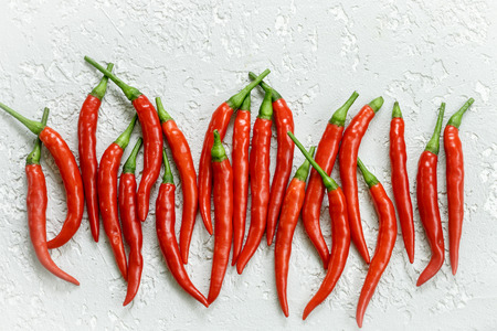 Red hot pepper pods close-up on a light background . Top view. Selective focusの写真素材