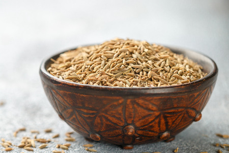 Cumin seeds (Zira) in a ceramic bowl close-up. Seasoning. Condiment.  Selective focusの写真素材