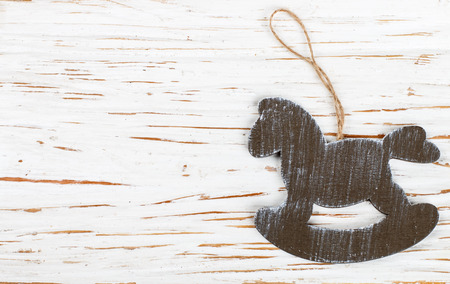 Christmas decoration-a wooden horse on an old white table.の写真素材