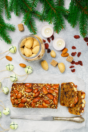 Fruitcake. Traditional Christmas cake with almonds, dried cranberries, cinnamon, cardamom, anise, cloves.の写真素材