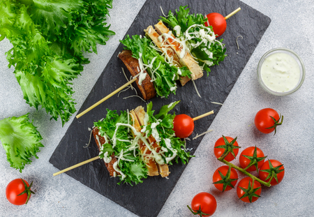 Delicious skewers of lettuce, chicken, cherry tomato, cheese and Caesar sauce. Salad on a stick. Selective focusの写真素材